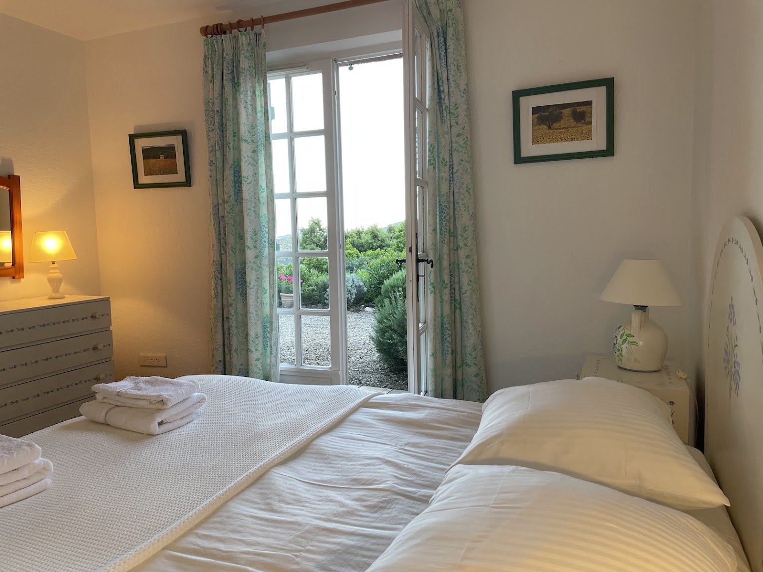 The ground-floor bedroom with French doors open to the garden