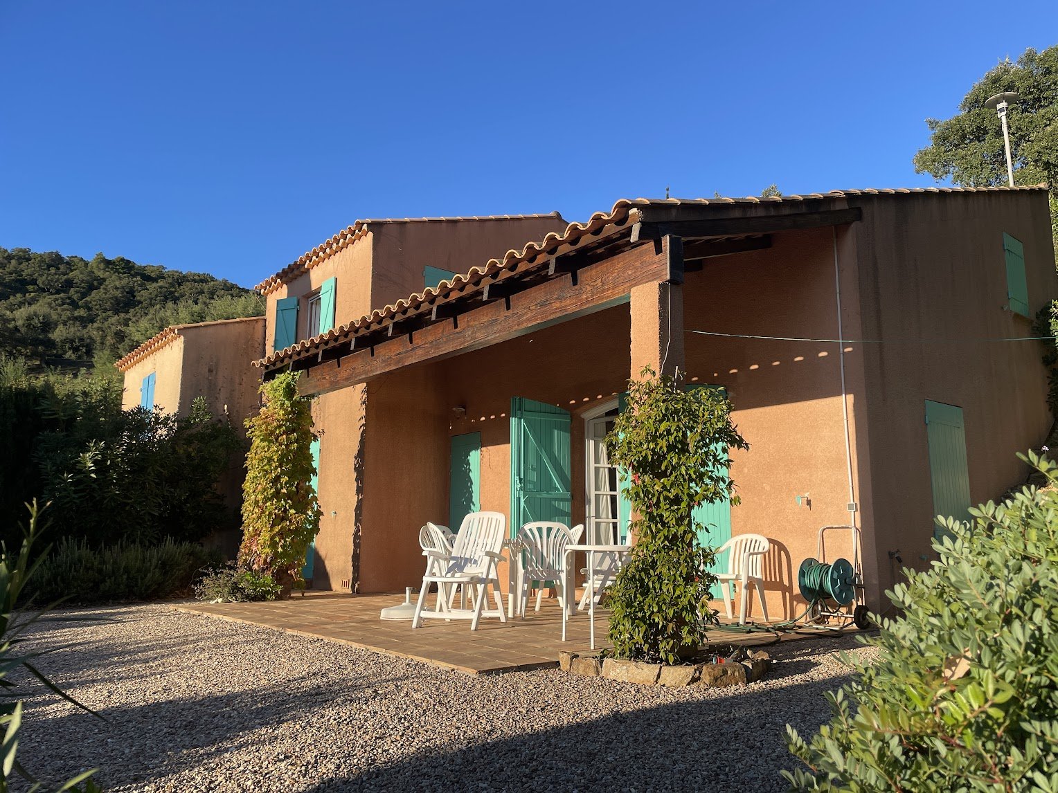 The exterior of Super Valmer — terracotta walls and green shutters